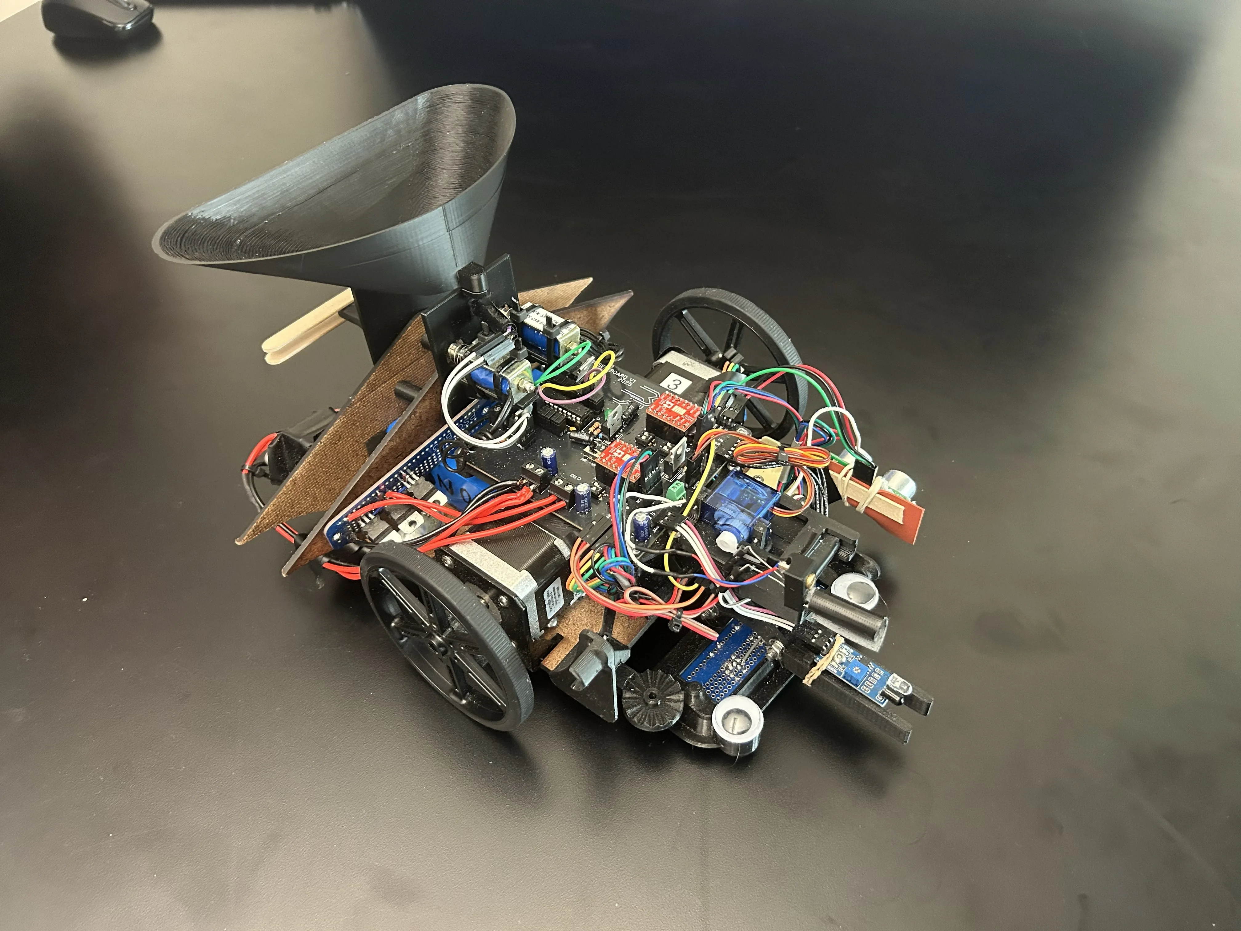Mini Mars rover prototype and team preparing for a Mars-themed autonomous mission course.