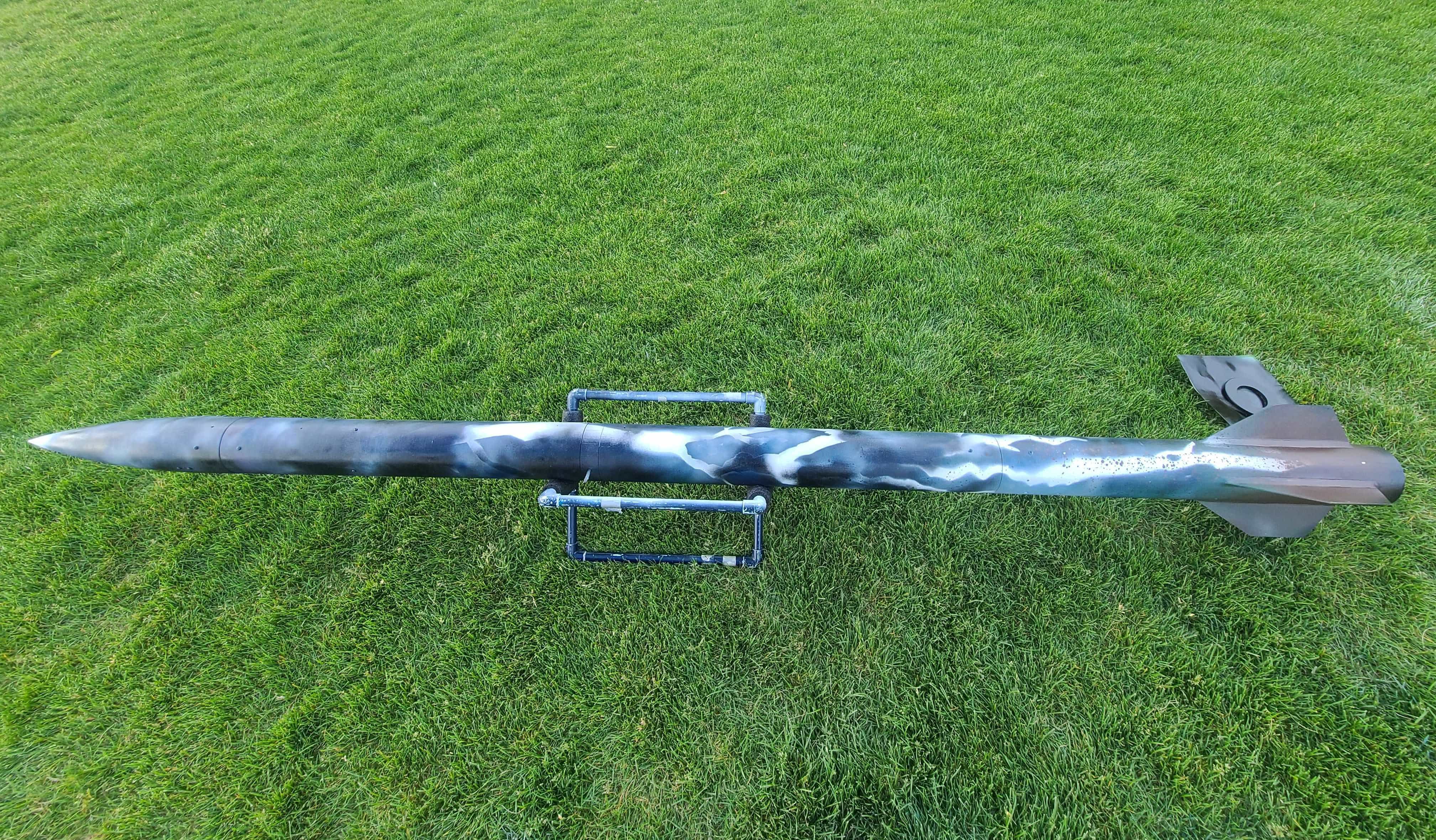 BYU Rocketry's Category V hybrid rocket on the launch pad with the water ballast payload integrated inside.
