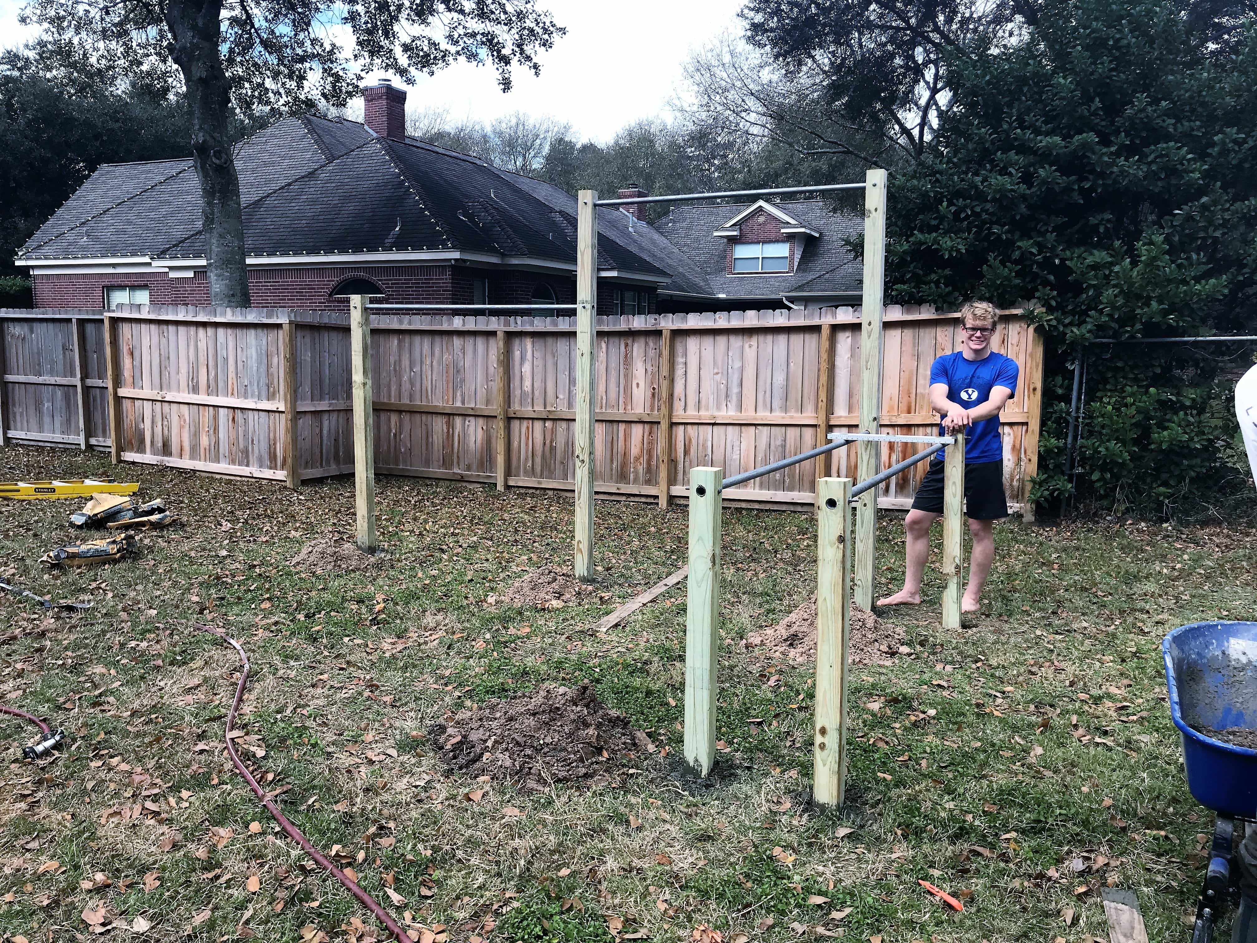 Completed backyard pull-up bar structure set in concrete and ready for use.